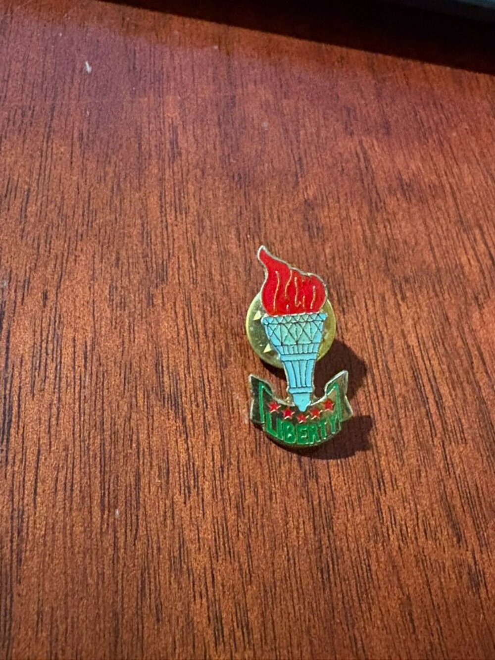 Liberty torch pin.